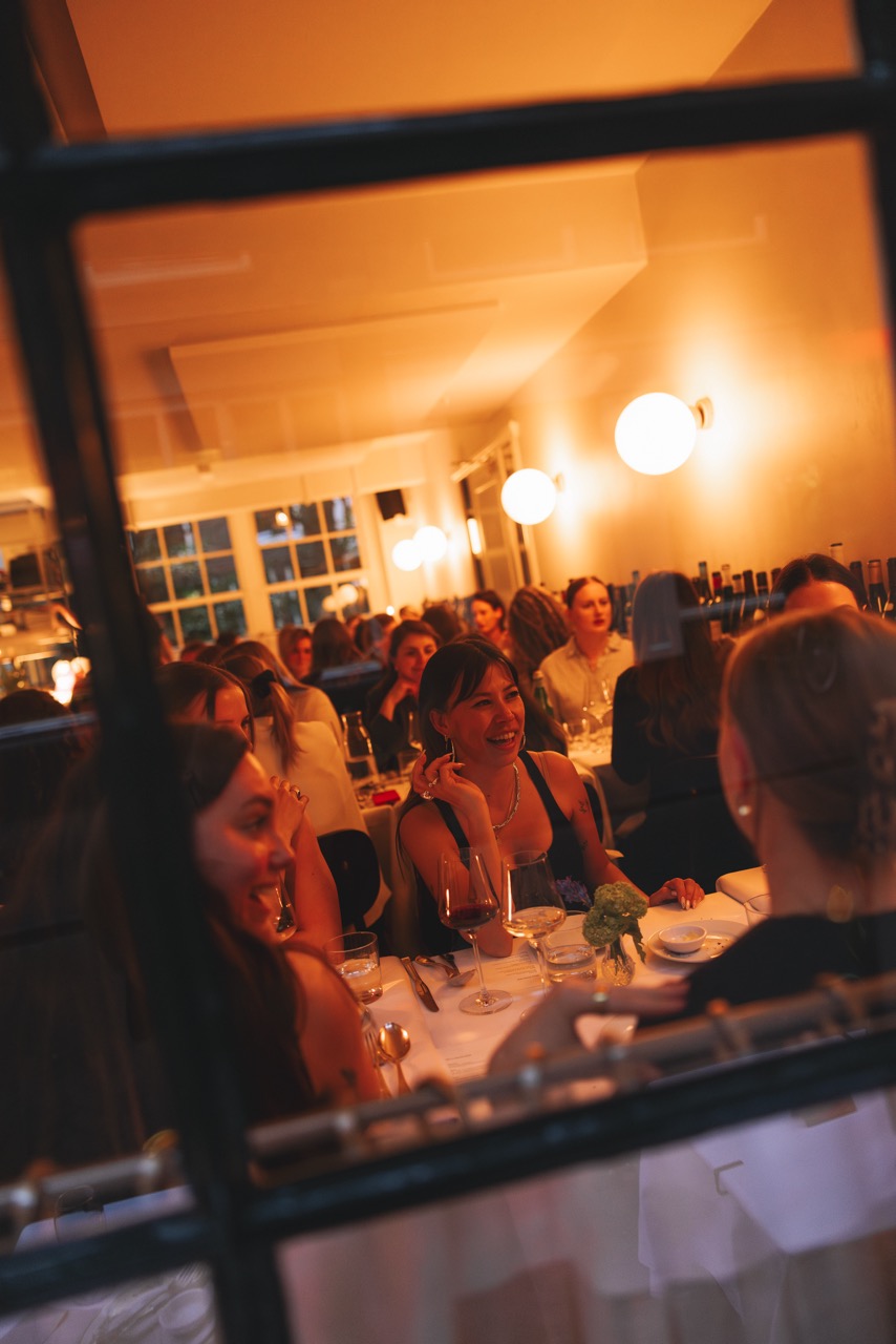 MOXIE members laughing at dinner